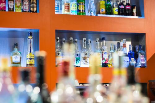 a row of bottles on a shelf in a bar at Kukubara Bowling Center in Myszków