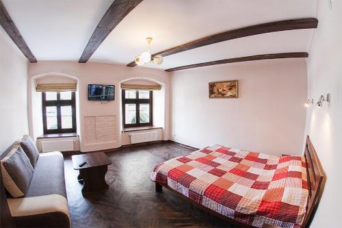 a bedroom with a bed and a couch at Квартира в центрі по вулиці Вірменська 12 дві спальні з двуспальними ліжками є інтернет сама Площа Ринок in Lviv