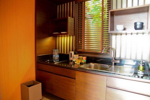 a kitchen with a sink and a counter top at Sri Panwa Phuket Luxury Pool Villa Hotel - SHA Plus in Panwa Beach