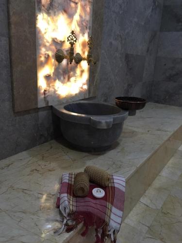 a bathroom with a tub and a towel on the floor at Vendome Hotel in Eskisehir