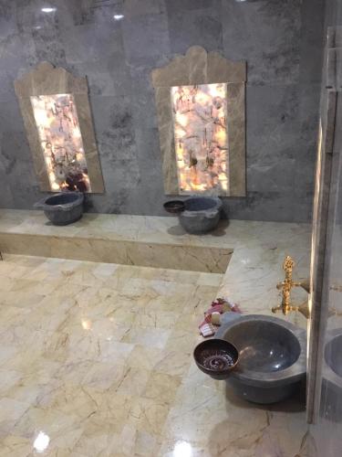 a bathroom with three sinks and a toilet in a room at Vendome Hotel in Eskisehir