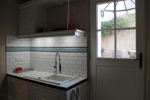 a kitchen with a sink and a window at l'Atelier de Saint-Just in Lyon