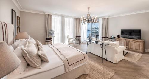 a bedroom with a large bed and a living room at Allium Bodrum Resort & Spa in Yalıkavak