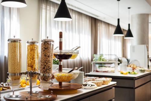 a kitchen with a counter with bowls of food at Hotel Bisesti ***S in Garda
