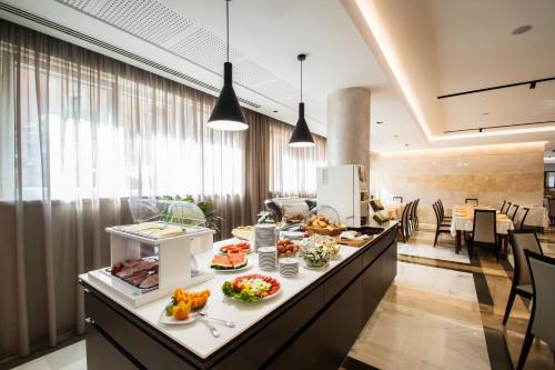 a breakfast bar in a hotel with food on it at Hotel Bisesti ***S in Garda