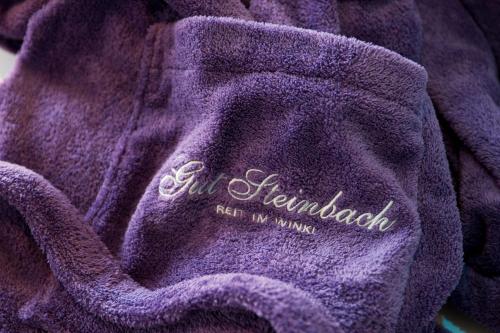 a purple sweater with the words all new england on it at Relais & Châteaux Gut Steinbach Hotel Chalets SPA in Reit im Winkl
