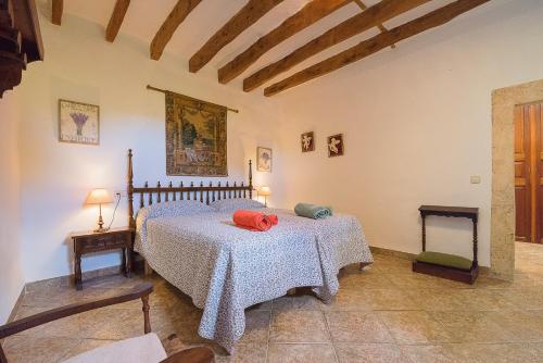 a bedroom with a bed and two tables in it at Son Caldés in Llucmajor