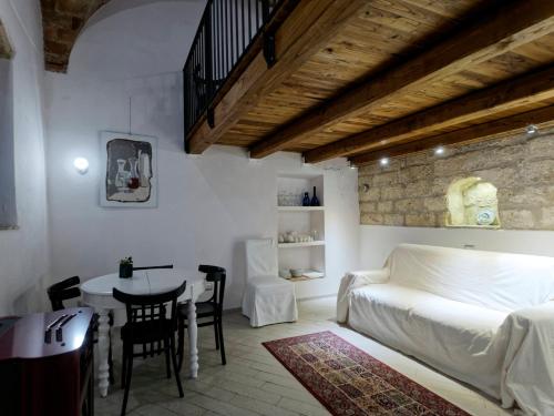 a bedroom with a bed and a table and a dining room at Loft 34 in Tarquinia
