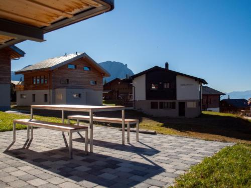 a bench sitting on top of a brick patio at Chalet Bergfink in Rosswald