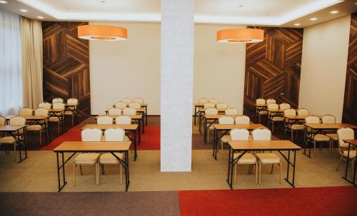 a classroom with tables and chairs in a room at Concept Hotel in Khimki