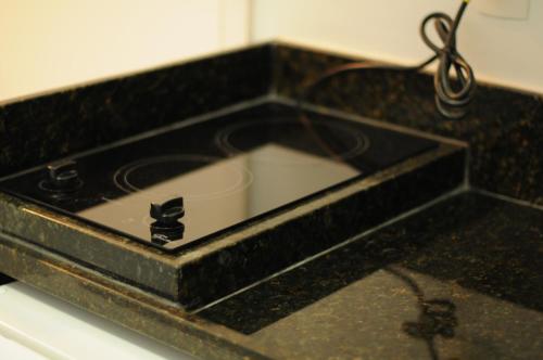 a black counter top with a sink in it at PEDAÇO DO PARAÍSO in Angra dos Reis