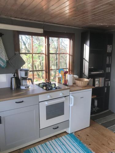 a kitchen with a white stove top oven at Farm Stay Happy Dogs Ranch in Veberöd