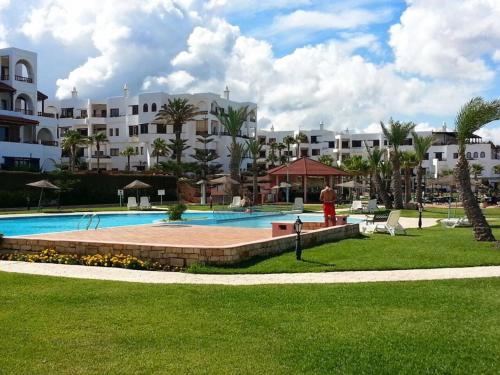 a resort with a swimming pool and buildings at Marina Beach Appartements in Restinga Smir