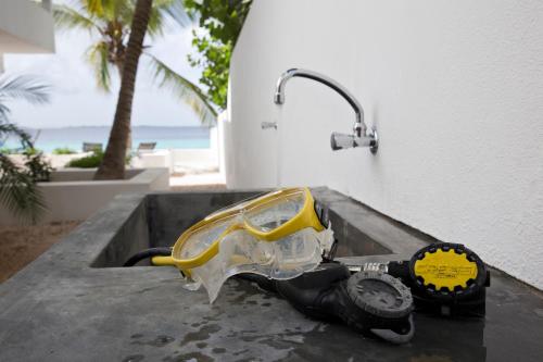 a motorcycleopter sitting on a table next to a building at One Ocean Boutique Apartments & Suites Bonaire in Kralendijk