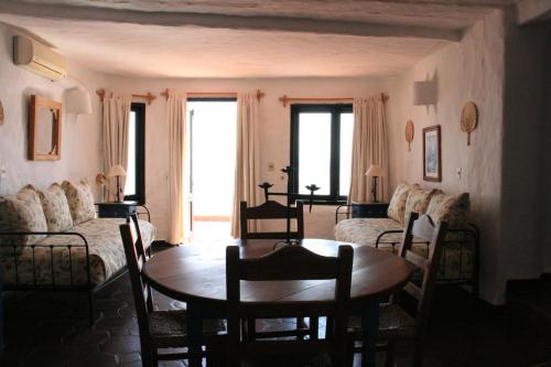 a living room with a table and a couch at Club Hotel Casapueblo in Punta del Este