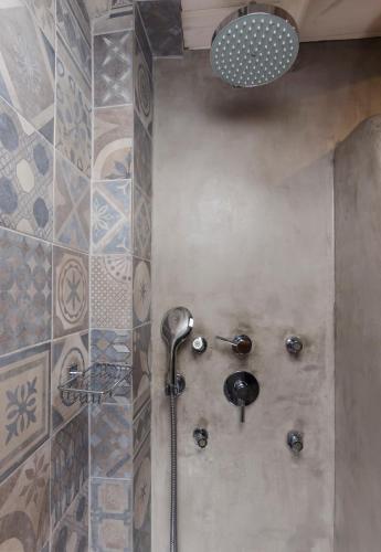 a shower with a shower head in a bathroom at Hotel Castillio in Analipsi