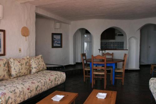 a living room with a couch and a table at Club Hotel Casapueblo in Punta del Este