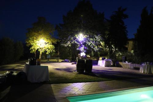 a park at night with tables and lights at Agriturismo Materno in Radicondoli