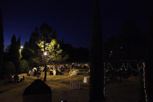 a group of people sitting in a park at night at Agriturismo Materno in Radicondoli