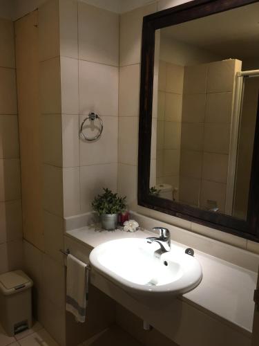 a bathroom with a sink and a mirror at Seaside Apartment at Cha-Am in Cha Am