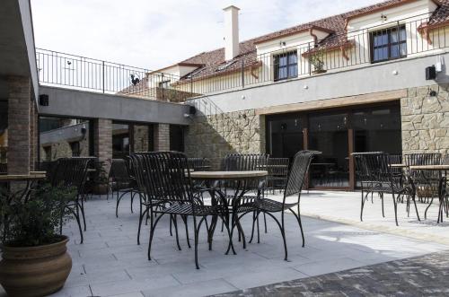 a patio with chairs and tables and a building at PROSECCO RESIDENCE MARKO in Valtice