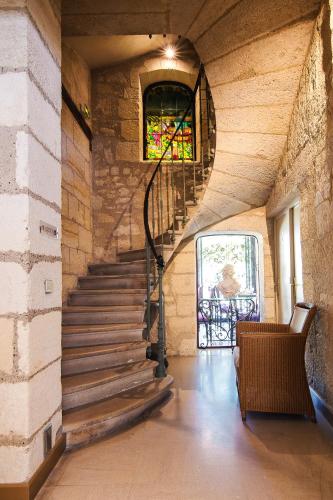 a staircase in a building with a stained glass window at Hôtel Au Logis des Remparts in Saint-Émilion