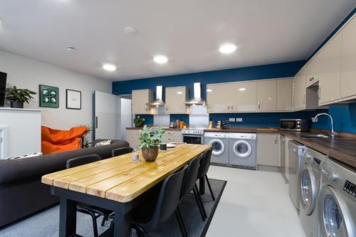 a kitchen and living room with a wooden table at Roseland House in Falmouth