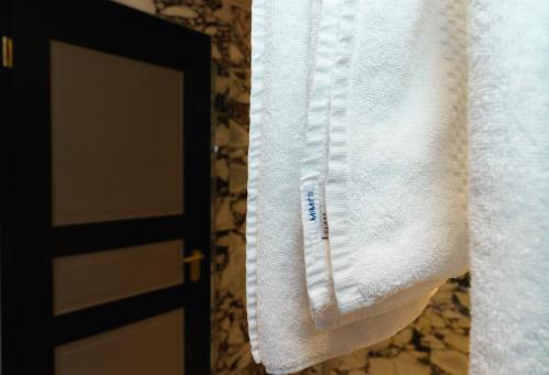 a towel hanging on a door in a bathroom at Mimi's Hotel Soho in London