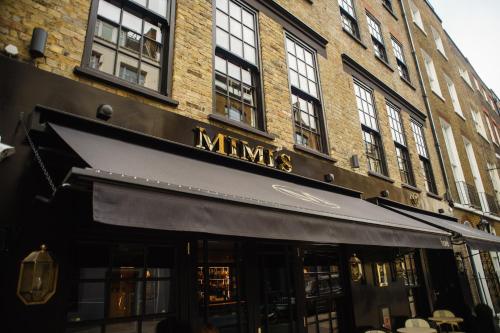 a store front of a building with a black awning at Mimi's Hotel Soho in London