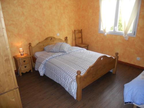 a bedroom with a wooden bed and two night stands at Auberge du Saut des Cuves in Xonrupt-Longemer