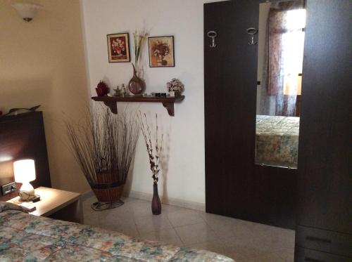 a bedroom with a bed and a window and a mirror at Alloggio privato Giunic in Cagliari