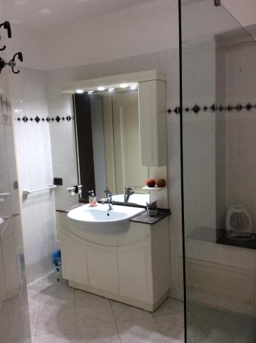 a bathroom with a sink and a mirror at Alloggio privato Giunic in Cagliari