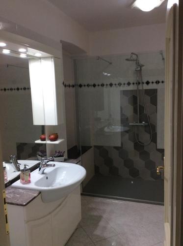 a bathroom with a sink and a shower at Alloggio privato Giunic in Cagliari
