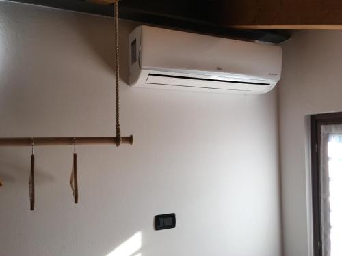a white air conditioner hanging from a ceiling at Casa Dany in Lugagnano