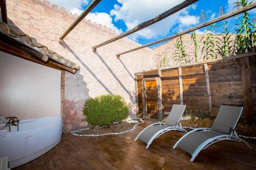 a bathroom with two chairs and a bath tub at Il Monastero in Geremèas