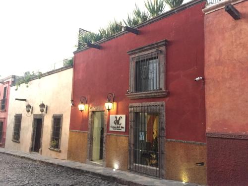 a red building on the side of a street at Casa del Tio Hotel Boutique in San Miguel de Allende