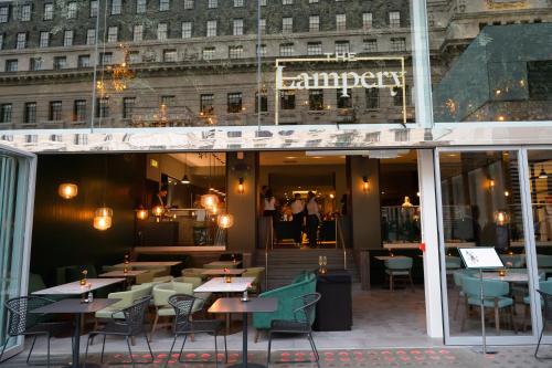 a restaurant with tables and chairs in front of a building at Apex City Of London Hotel in London