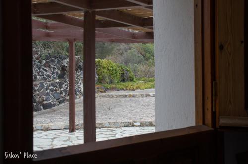 an open window with a view of a patio at Siskosplace in Oia