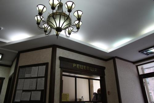 a chandelier hangs over the entrance to a hotel at Nashe Misto Guest House in Kovelʼ