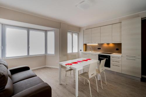 a living room with a white table and chairs at Lake Como Apartments in Lecco