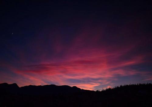 a sunset with a purple and red sky at Cozy Loft - Best view of the city in Lamía