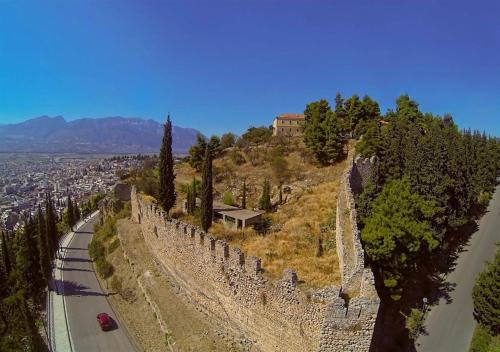 a castle on a hill next to a road at Cozy Loft - Best view of the city in Lamía