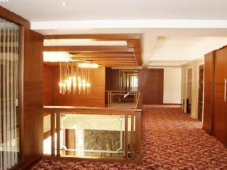 a hallway of a hotel with a fireplace at Parijatha Gateway in Bengaluru