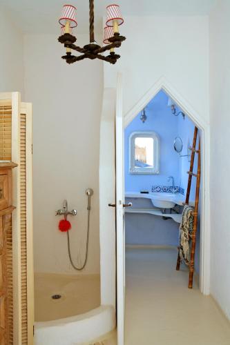 a bathroom with a shower with a blue wall at Villa Martha in Kea in Koundouros