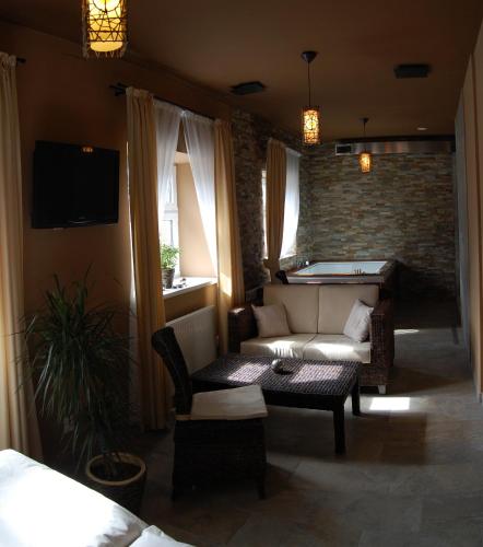 a living room with a couch and a pool table at Hotel RICHTR in Frýdek-Místek