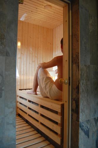 a man is sitting in a sauna at Hotel RICHTR in Frýdek-Místek