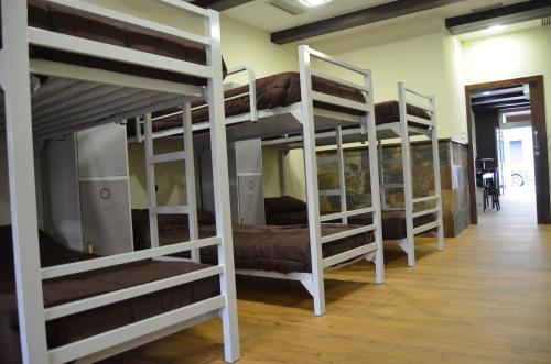 a row of bunk beds in a room at Albergue del Peregrino in Arzúa