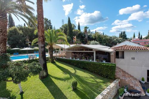 an aerial view of a house with a pool and palm trees at Anita in Perama