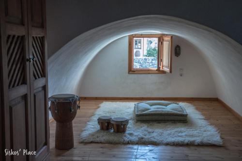 a bedroom with a bed in a room with a window at Siskosplace in Oia