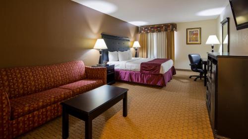 a hotel room with a bed and a couch at Best Western - Saluki Inn in Carbondale